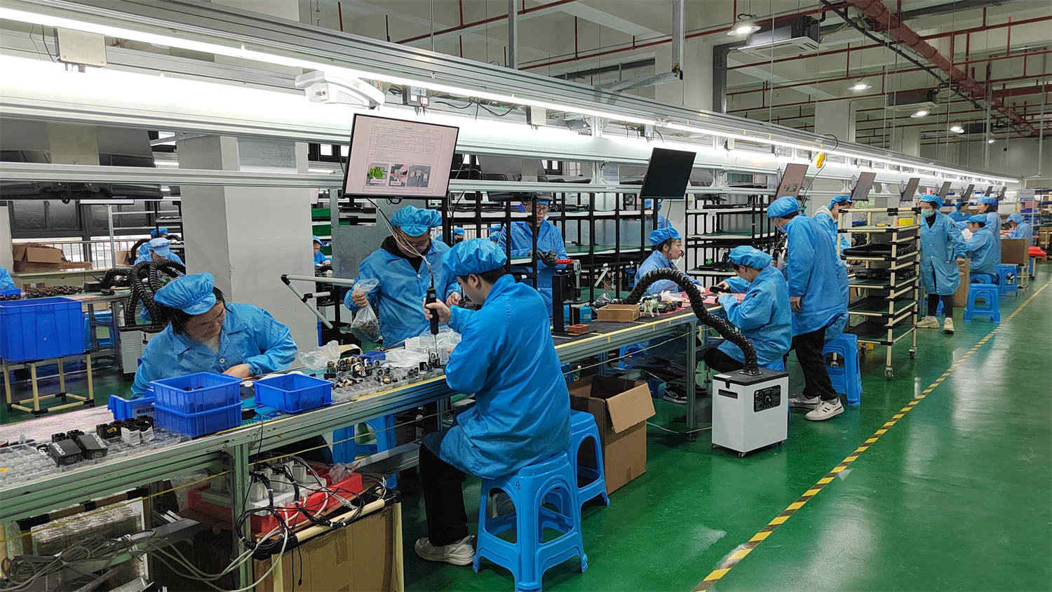 Workers assembling smart electric bike pumps